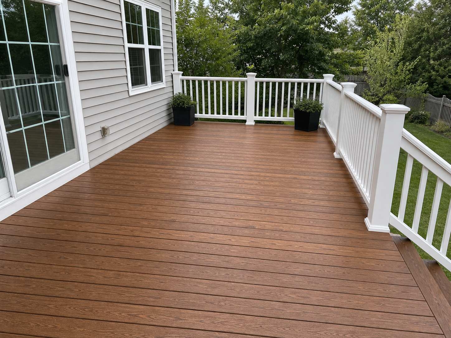 Deck after staining — rich warm brown finish